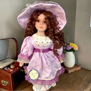 Vintage Porcelain Doll with original tags & metal stand